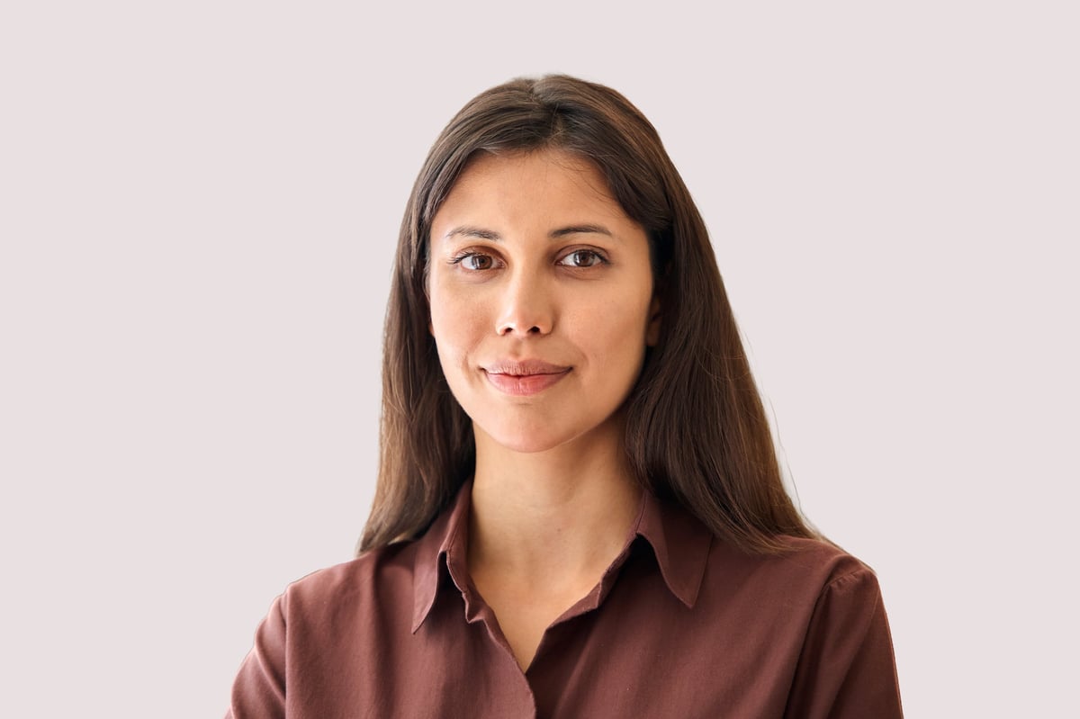 Headshot closeup portrait middle eastern or latin businesswoman, business lady standing isolated on grey background